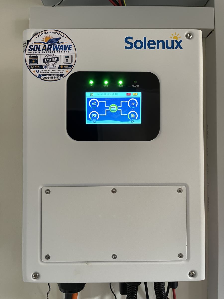 Close-up of a wall-mounted hybrid inverter showing live system status